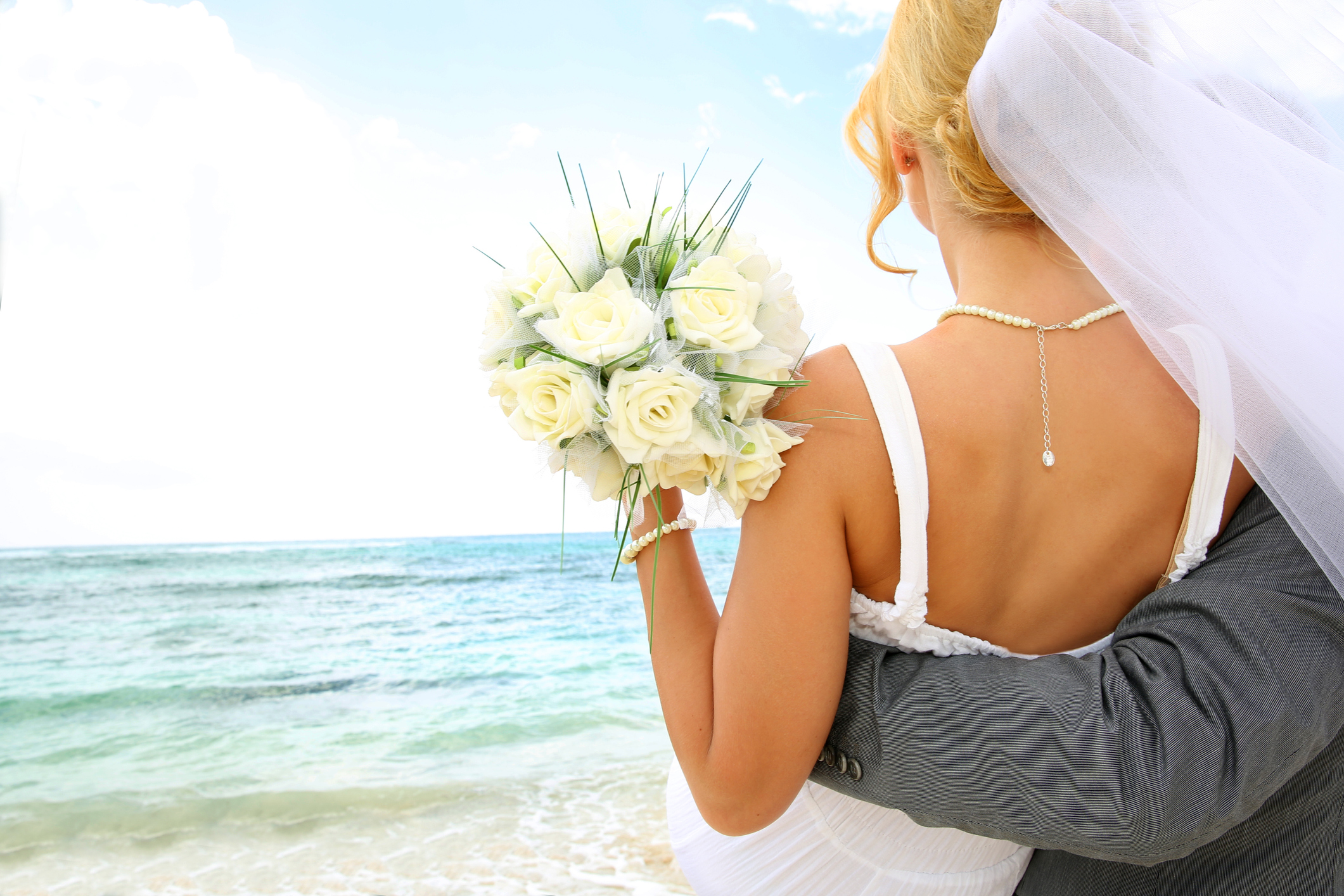 Groom holding his bride by the ocean Sandals Wedding Packages. Sandals Wedding Packages: Our All-Inclusive Guide for 2025. If you’re about to get hitched, why not do it in one of the most heavenly places on the planet? The Caribbean is blessed with azure waters, powdery sands — and all-inclusive resorts like Sandals that will help you plan for your big day. Here’s everything you need to know about Sandals wedding packages..
